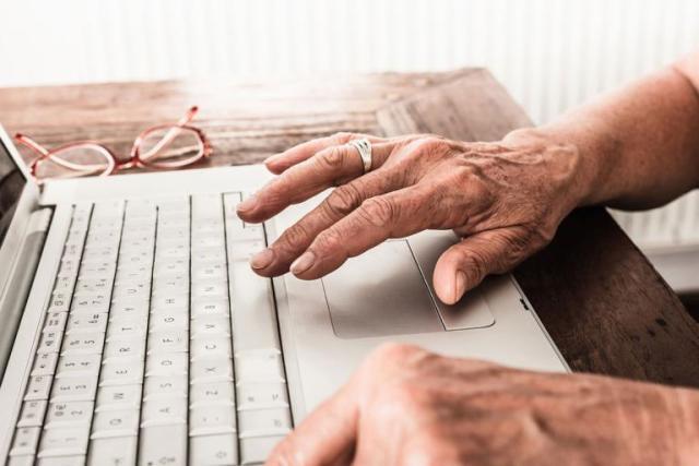 Hands on a laptop keyboard